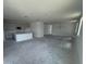 Open-concept living area with kitchen, dining space, and plenty of natural light from large windows at 30112 Misty Pines Rd, Mount Dora, FL 32757