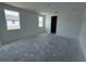 Living room area featuring two windows and doorway at 30112 Misty Pines Rd, Mount Dora, FL 32757