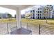 Relaxing outdoor balcony with a table and chairs overlooking a landscaped community at 3150 Paradox Cir # 102, Kissimmee, FL 34746