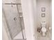 Bathroom featuring a glass-enclosed shower and a separate toilet area with framed artwork at 3150 Paradox Cir # 102, Kissimmee, FL 34746