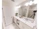 Bright bathroom featuring double sinks, modern fixtures, and a large mirror reflecting a shower at 3150 Paradox Cir # 102, Kissimmee, FL 34746