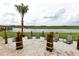 Outdoor sandy lounge area features comfortable chairs and scenic lake views, perfect for relaxation and socializing at 3150 Paradox Cir # 102, Kissimmee, FL 34746