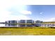 Modern condo complex with pond views and a wooden bridge walkway on a clear, sunny day at 3150 Paradox Cir # 102, Kissimmee, FL 34746