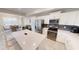 Modern kitchen featuring white cabinets, stainless steel appliances, and a breakfast bar at 3150 Paradox Cir # 102, Kissimmee, FL 34746