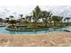 Picturesque lazy river surrounded by lush landscaping and palm trees at 3150 Paradox Cir # 102, Kissimmee, FL 34746