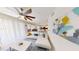 Bright, open-concept living room with a ceiling fan and stylish decor, adjacent to the dining area at 3150 Paradox Cir # 102, Kissimmee, FL 34746