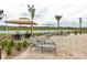 Lounge area with chairs and tables with lake view, providing a relaxing outdoor space at 3150 Paradox Cir # 102, Kissimmee, FL 34746