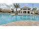 Resort-style pool with lounge chairs, palm trees, and a tiki hut for relaxation at 3150 Paradox Cir # 102, Kissimmee, FL 34746