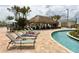 Inviting poolside cabana area with lounge chairs, tables, and shade, perfect for relaxation by the pool at 3150 Paradox Cir # 102, Kissimmee, FL 34746