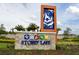 Beautiful community sign reading 'Storey Lake' surrounded by lush landscaping and colorful flowers at 3150 Paradox Cir # 102, Kissimmee, FL 34746