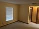Bright bedroom with large window providing natural light and ensuite access to the bathroom at 3152 Clewiston St, Deltona, FL 32738