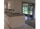 The well-maintained kitchen boasts white cabinets, neutral countertops, and tiled floors at 3152 Clewiston St, Deltona, FL 32738