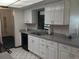 Classic kitchen features white cabinets, stainless steel sink, and neutral countertops at 3152 Clewiston St, Deltona, FL 32738