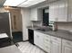 Modern kitchen featuring white cabinets, stainless steel appliances and ample counter space, offering both style and functionality at 3152 Clewiston St, Deltona, FL 32738