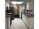 Bright kitchen showcases white cabinetry, neutral countertops, and black and white tile floors at 3152 Clewiston St, Deltona, FL 32738