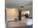 Living area flows into the kitchen with white cabinets and gray countertop at 3152 Clewiston St, Deltona, FL 32738