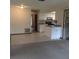 Open-concept living area flows into kitchen with white cabinetry and tiled floors at 3152 Clewiston St, Deltona, FL 32738