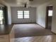 Expansive living area featuring a ceiling fan, neutral carpeting, and bright natural light at 3152 Clewiston St, Deltona, FL 32738