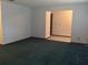 Inviting living room features neutral walls, green carpet, and an open layout to an adjacent room at 3152 Clewiston St, Deltona, FL 32738