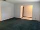 Inviting living room features neutral walls, green carpet, and an open layout to an adjacent room at 3152 Clewiston St, Deltona, FL 32738