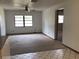 Open living room featuring carpet flooring, ceiling fan, and large window at 3152 Clewiston St, Deltona, FL 32738