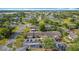 Aerial view of the community, showing lush landscaping, ample parking, and proximity to a playground and pond at 3208 W Tower Ct, Kissimmee, FL 34741