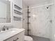 Bathroom features a vanity with marble countertop, decorative baskets, and tiled shower at 3208 W Tower Ct, Kissimmee, FL 34741