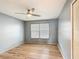 A light and airy bedroom boasts a ceiling fan and wood-look flooring at 3208 W Tower Ct, Kissimmee, FL 34741