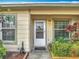 Inviting front entrance with a white door, well-maintained landscaping, and bright windows on either side at 3208 W Tower Ct, Kissimmee, FL 34741