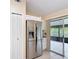 Kitchen with stainless steel refrigerator, white cabinets, and sliding door to the outside at 3208 W Tower Ct, Kissimmee, FL 34741