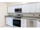 Bright and modern kitchen with stainless steel appliances, ample countertop space, and stylish white cabinets at 3208 W Tower Ct, Kissimmee, FL 34741