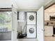 Convenient laundry closet with stacked washer and dryer, along with water heater, for efficient use of space at 3208 W Tower Ct, Kissimmee, FL 34741