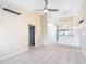 Bright living room boasts tile flooring, a ceiling fan, and neutral walls that create a spacious and airy atmosphere at 3208 W Tower Ct, Kissimmee, FL 34741