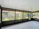 A screened patio with a view of the yard and surrounding greenery at 3208 W Tower Ct, Kissimmee, FL 34741