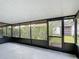 Screened in patio features views of plants, the yard, and nearby houses at 3208 W Tower Ct, Kissimmee, FL 34741