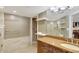 Bathroom features spacious vanity, mirror reflecting shower, and convenient storage shelves at 400 E Colonial Dr # 1202, Orlando, FL 32803