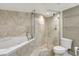 Bathroom features both a soaking tub and a glass-enclosed shower, along with modern fixtures at 400 E Colonial Dr # 1202, Orlando, FL 32803