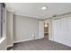 A well-lit bedroom features a window and an open door framing a beautiful chandelier at 400 E Colonial Dr # 1202, Orlando, FL 32803