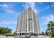Striking view of a modern high-rise apartment building with many balconies and white facade at 400 E Colonial Dr # 1202, Orlando, FL 32803