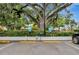 Residential car wash zone featuring signage and equipment under a large shady tree canopy at 400 E Colonial Dr # 1202, Orlando, FL 32803