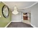 Dining room features a decorative chandelier and large mirror with an open view to the kitchen at 400 E Colonial Dr # 1202, Orlando, FL 32803