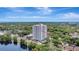 Stunning exterior view of a condo in high rise building with beautiful landscaping and a lake at 400 E Colonial Dr # 1202, Orlando, FL 32803