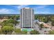 Exterior building view with a pool, parking lot, and beautiful lake and skyline at 400 E Colonial Dr # 1202, Orlando, FL 32803