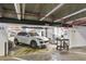 Well-lit parking garage with a white SUV, featuring numbered parking spots and garage air hose station at 400 E Colonial Dr # 1202, Orlando, FL 32803