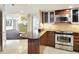 Modern kitchen featuring sleek countertops, stainless steel appliances, and wood cabinetry at 400 E Colonial Dr # 1202, Orlando, FL 32803