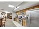 The small kitchen is accessible from the gathering room and features stainless steel appliances and wood cabinets at 400 E Colonial Dr # 1202, Orlando, FL 32803