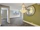 Bright living room features a decorative chandelier, large mirror, and stunning city views at 400 E Colonial Dr # 1202, Orlando, FL 32803