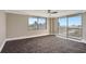 Bright living room with floor-to-ceiling windows showcasing panoramic city views and access to a balcony at 400 E Colonial Dr # 1202, Orlando, FL 32803