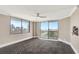 Bright living room with floor-to-ceiling windows showcasing panoramic city views and access to a balcony at 400 E Colonial Dr # 1202, Orlando, FL 32803