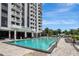 Large, pristine outdoor swimming pool at Park Lake Towers, lined with lounge chairs and landscaping at 400 E Colonial Dr # 1202, Orlando, FL 32803